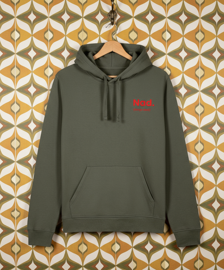 Khaki green hoodie with red text on a hanger against a patterned wall.