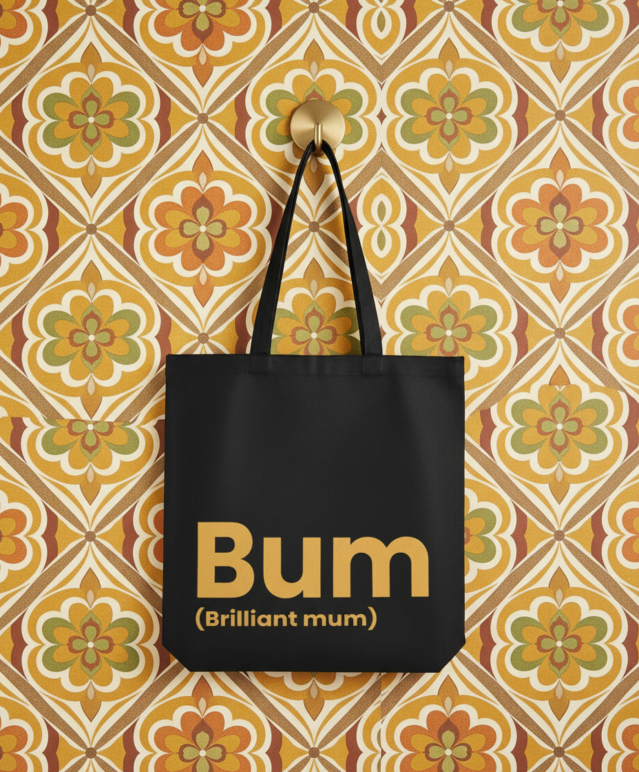 Black tote bag with 'Bum (Brilliant mum)' text on a patterned wall background
