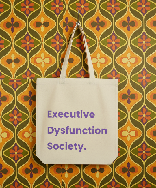 Tote bag with 'Executive Dysfunction Society' text on a patterned wall background