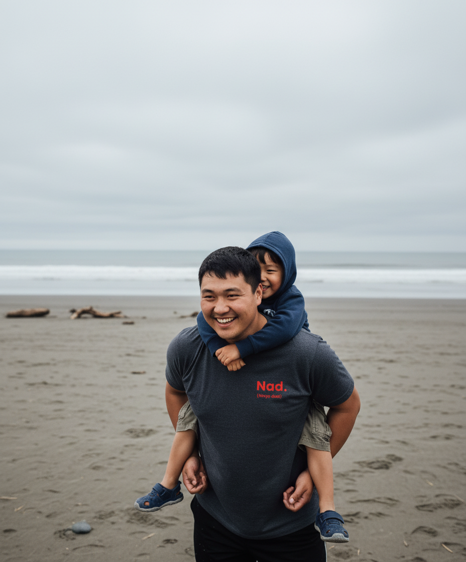 Man carrying a child on his shoulders at the beach