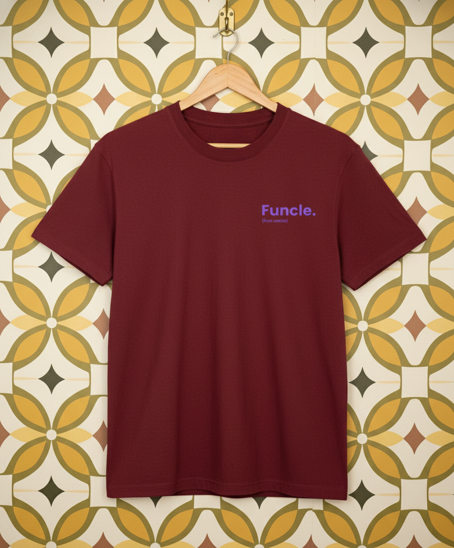 Maroon t-shirt with 'Funcle' logo on a hanger against a patterned wall.