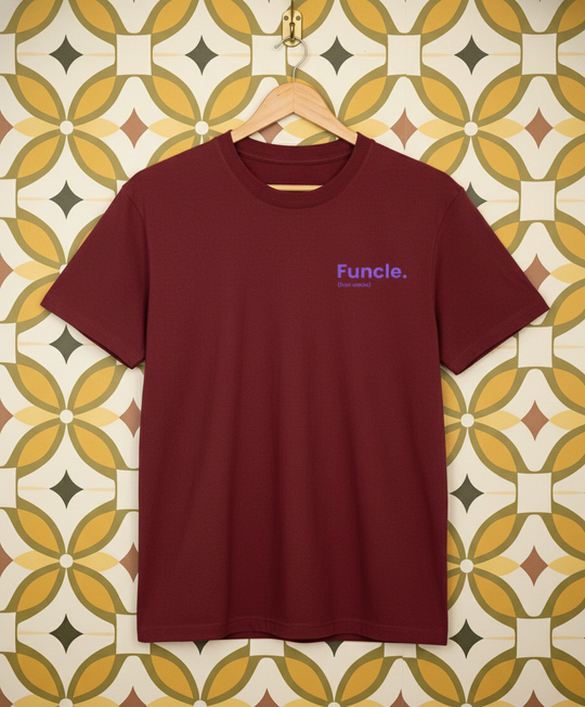 Maroon t-shirt with 'Funcle' logo on a hanger against a patterned wall.