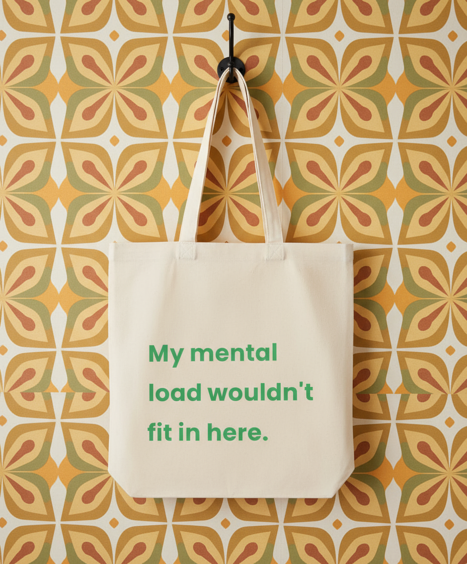 Beige tote bag with green text against a patterned wall