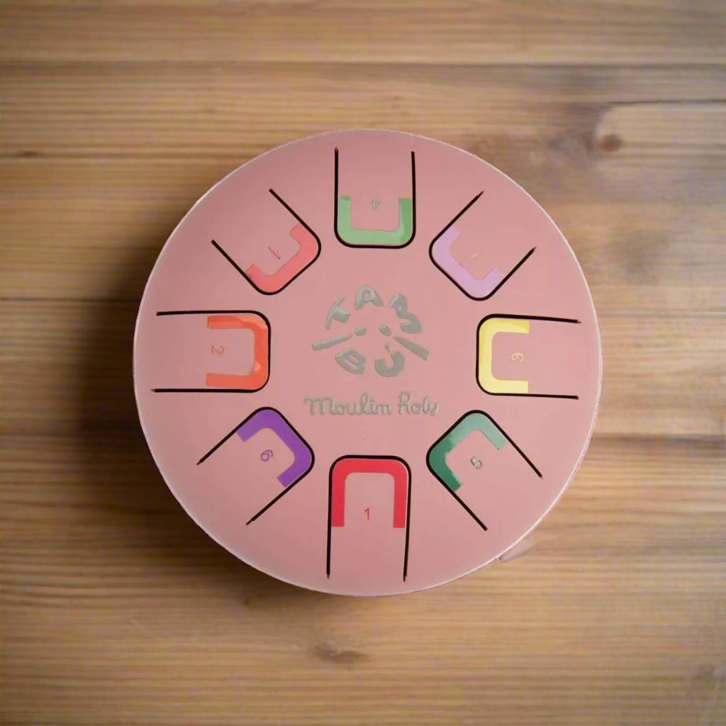 Pink metal tongue drum instrument with colour coded notes