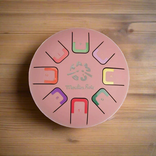 Pink metal tongue drum instrument with colour coded notes
