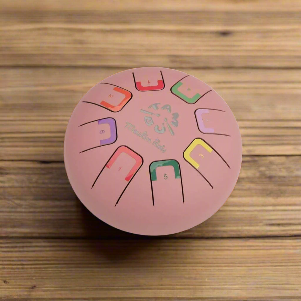 Pink metal tongue drum instrument with coloured metal notes