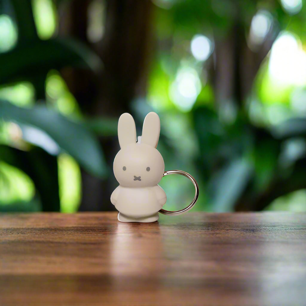 Beige rabbit-shaped keyring with iconic cross stitched mouth