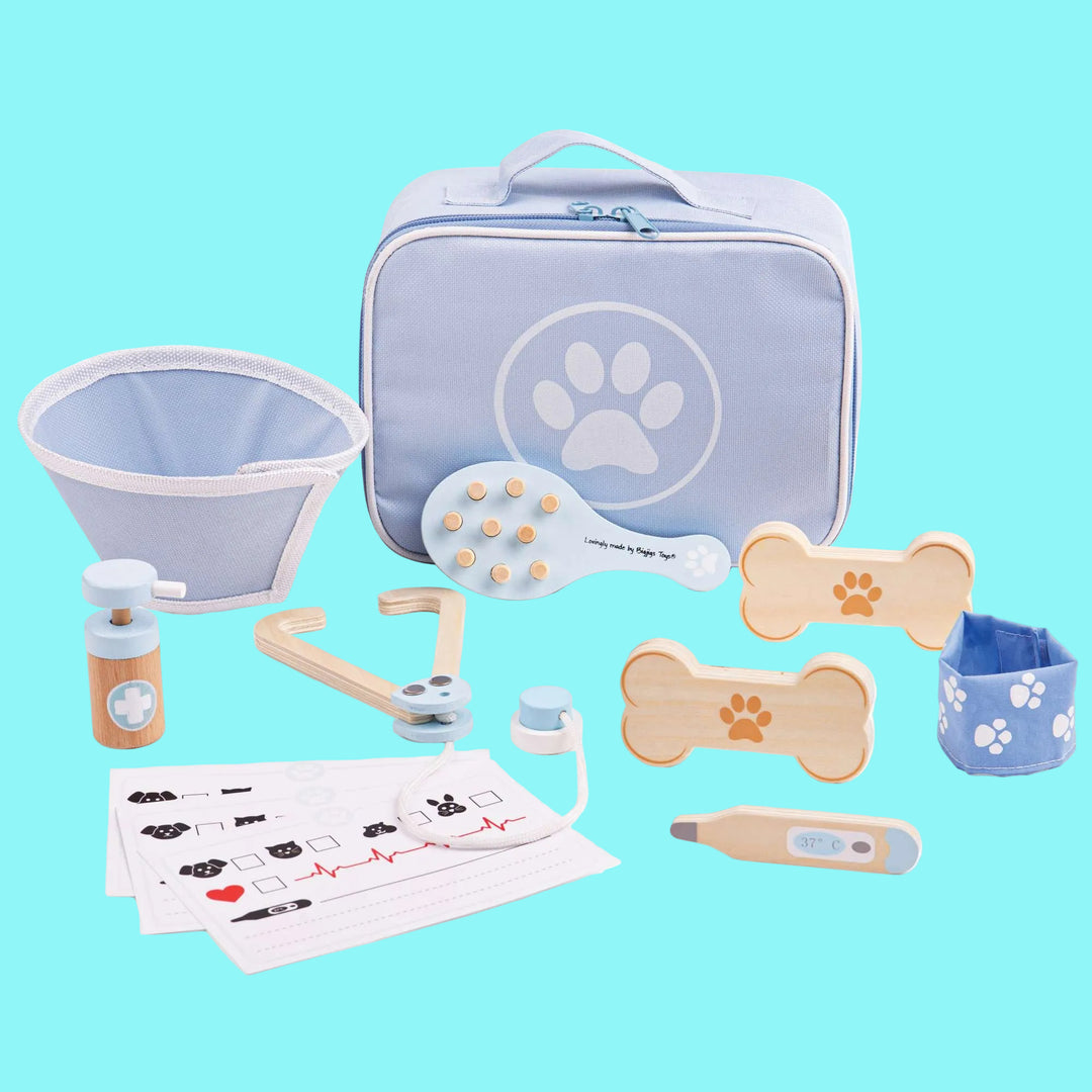 Set of toy veterinary tools and equipment with a blue carrying case on a white background