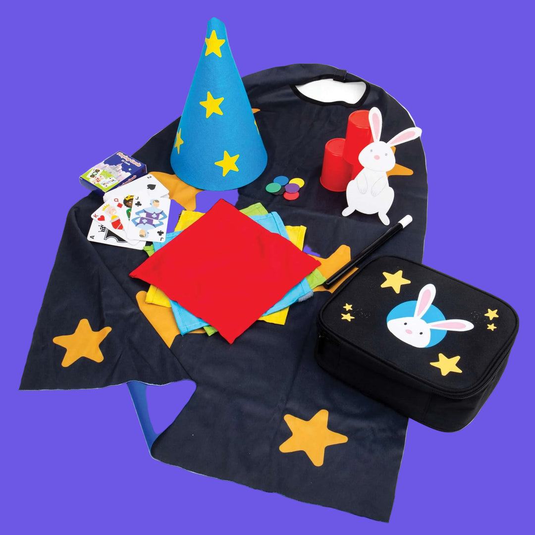 Magic show set with a blue wizard hat, red cape, black bag, and rabbit design on a white background.