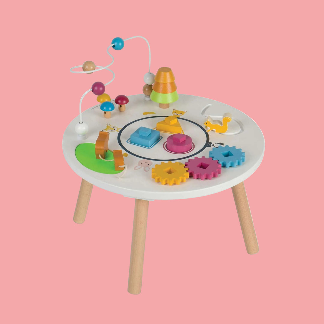 Colorful children's activity table with various educational toys on a white background