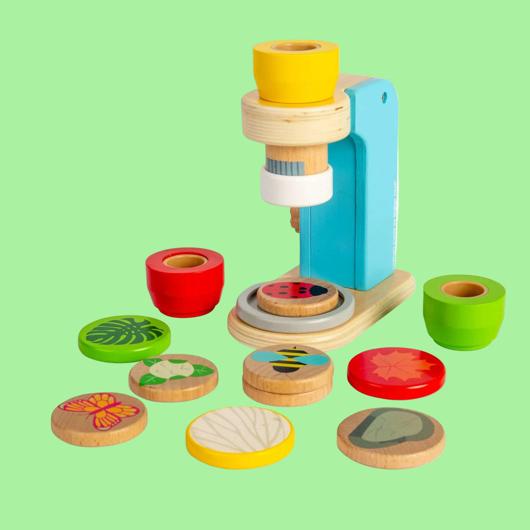 Colorful wooden toy with cylindrical pieces and circular cutouts on a white background