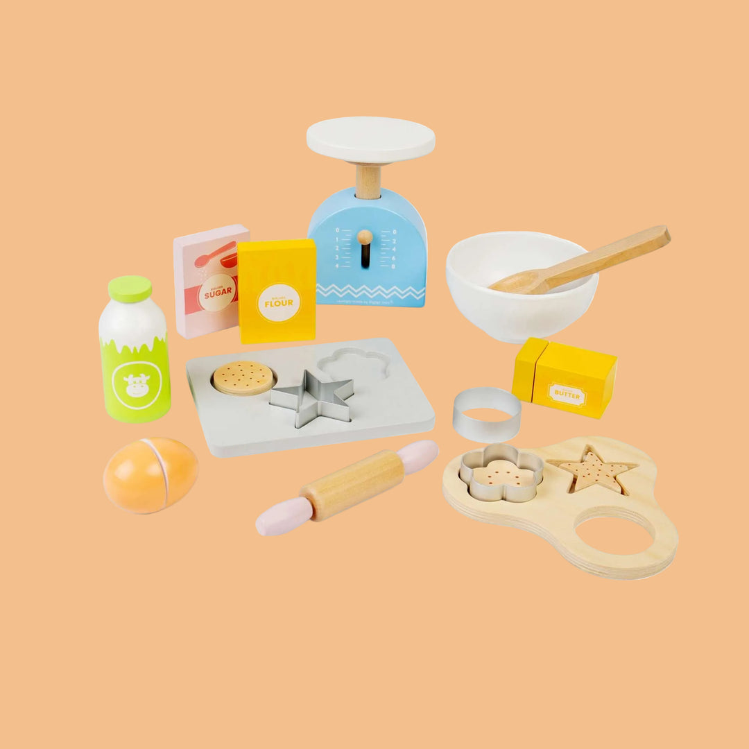 Collection of wooden kitchen playset items on a white background