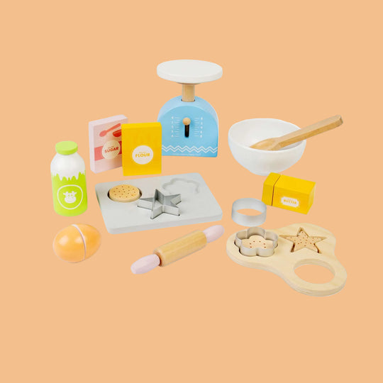 Collection of wooden kitchen playset items on a white background