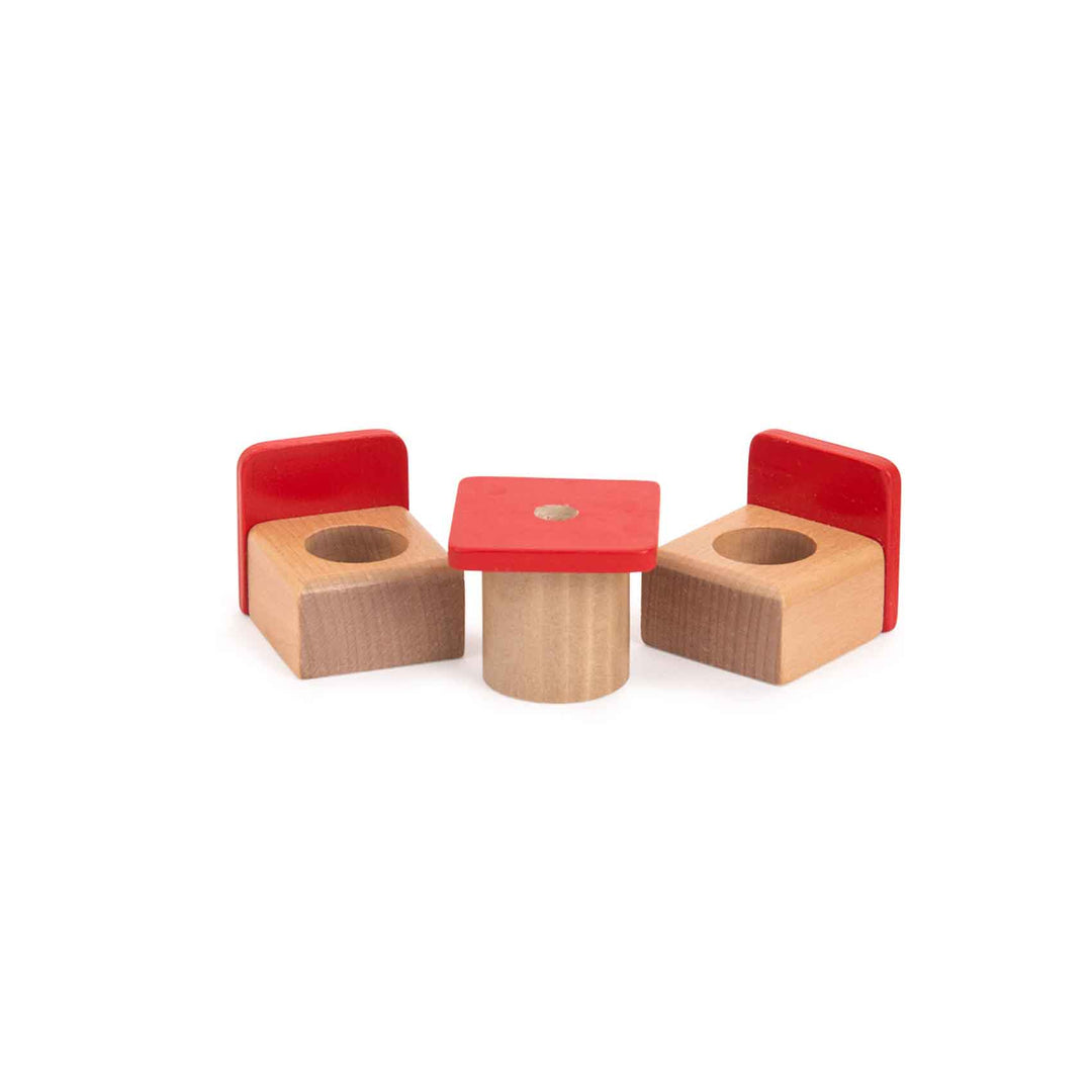 Set of wooden chairs with red seats and a small table on a white background