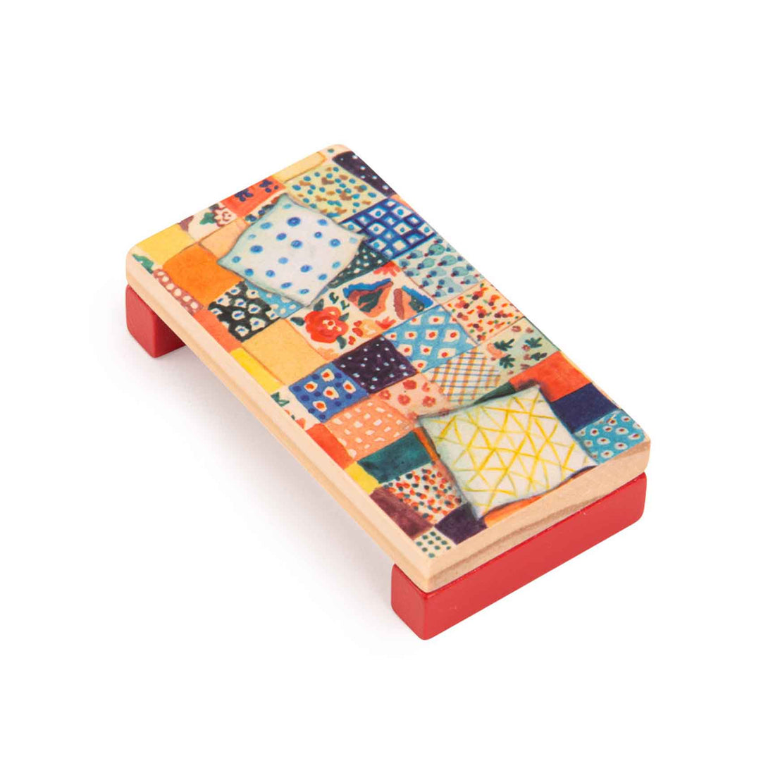 Colorful patterned wooden bed with patchwork quilt design