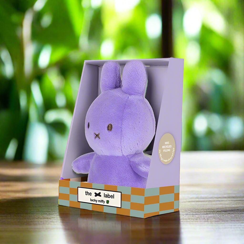 Purple plush stuffed toy rabbit in gift box angled to the left