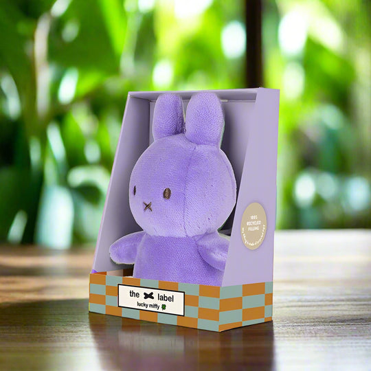 Purple plush stuffed toy rabbit in gift box angled to the left