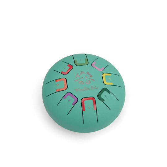 Round teal coloured metal tongue drum with colour-coded notes