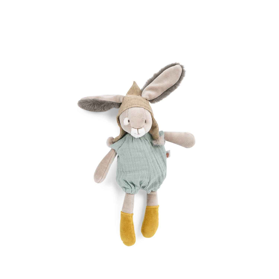Stuffed rabbit eith fluffy ears sticking out of hat with bobbles. It is wearing a pale turquoise romper and has mustard yellow shoes