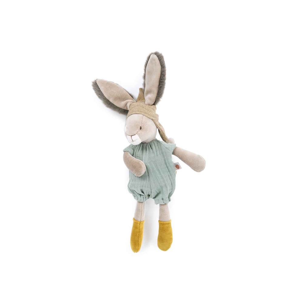 Stuffed rabbit turned to the side, wearing pale turquoise romper and yellow shoes with fluffy ears poking out of hat