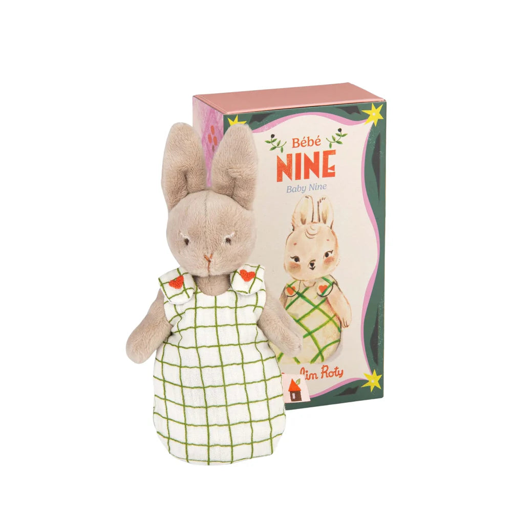 Plush toy rabbit in a dress with packaging labeled 'Bébé Nine' on a white background