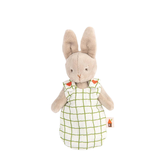 Stuffed rabbit toy wearing a white dress with green lines on a white background