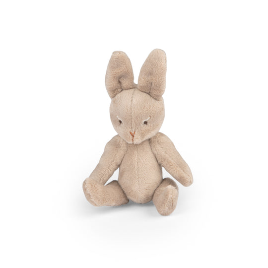 Stuffed rabbit toy sitting down without the sleepsack on