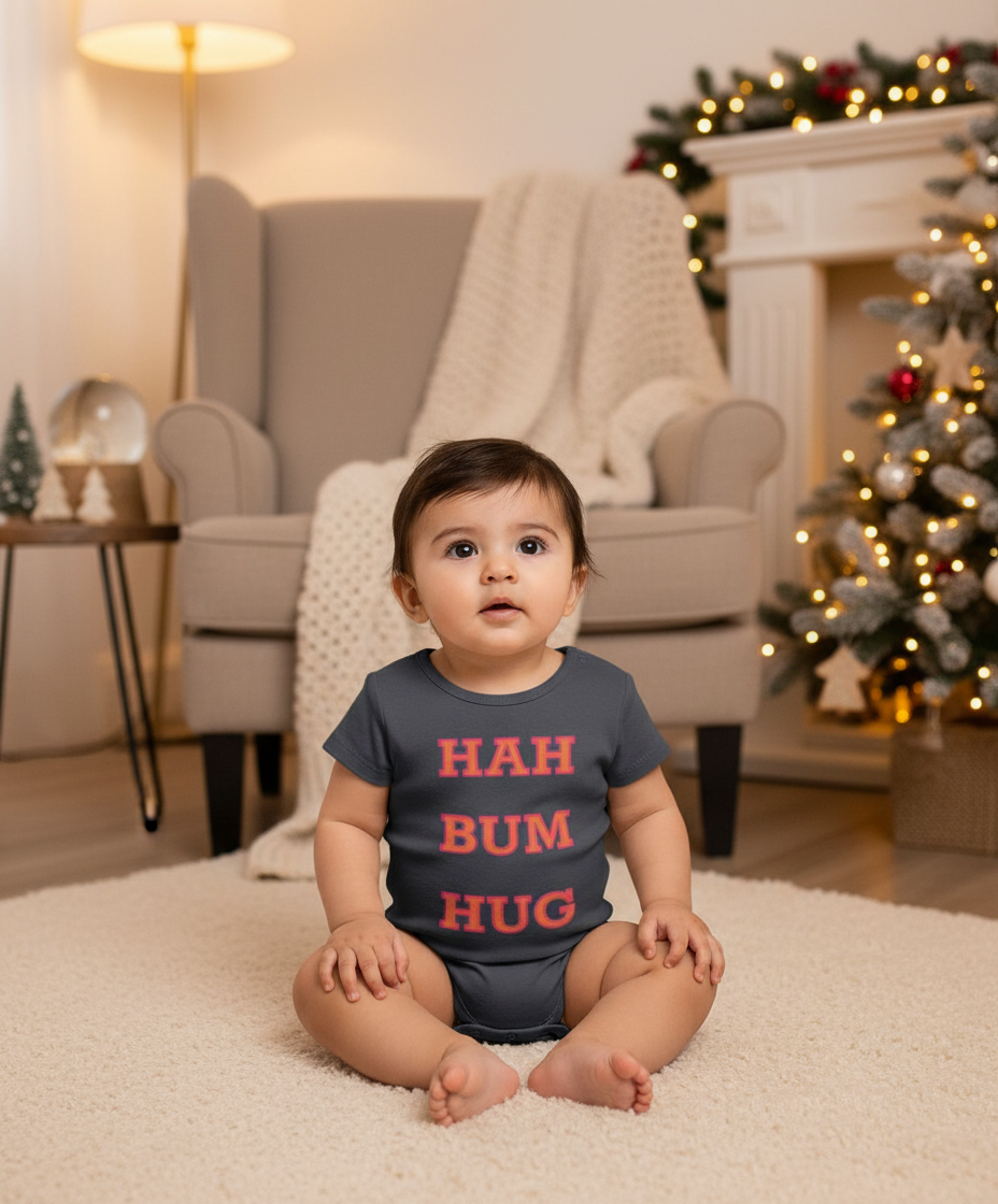 Baby sitting on a carpeted floor wearing a onesie with 'HAH BUM HUG' text in a festive room.