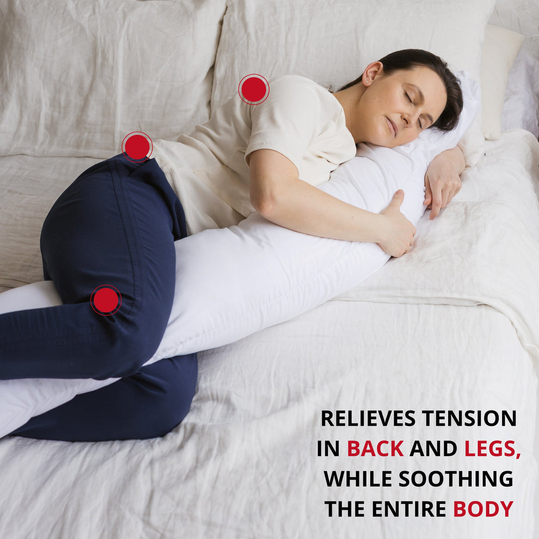 Person lying on a bed with a neck and back support pillow, with text reading 'relieves tension in back and legs, while soothing the entire body'
