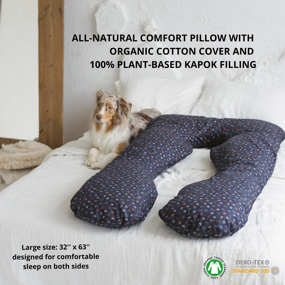 All-natural comfort pillow with organic cotton cover and plant-based kapok filling on a bed with a dog.