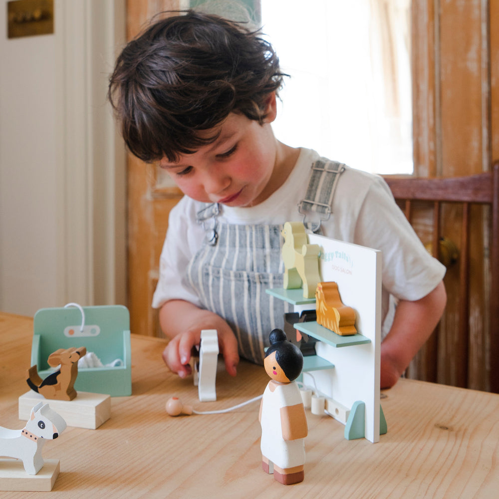 Child playing with wooden toys on a table
