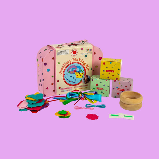 Jewelry making kit with colorful components and a pink polka dot box on a white background