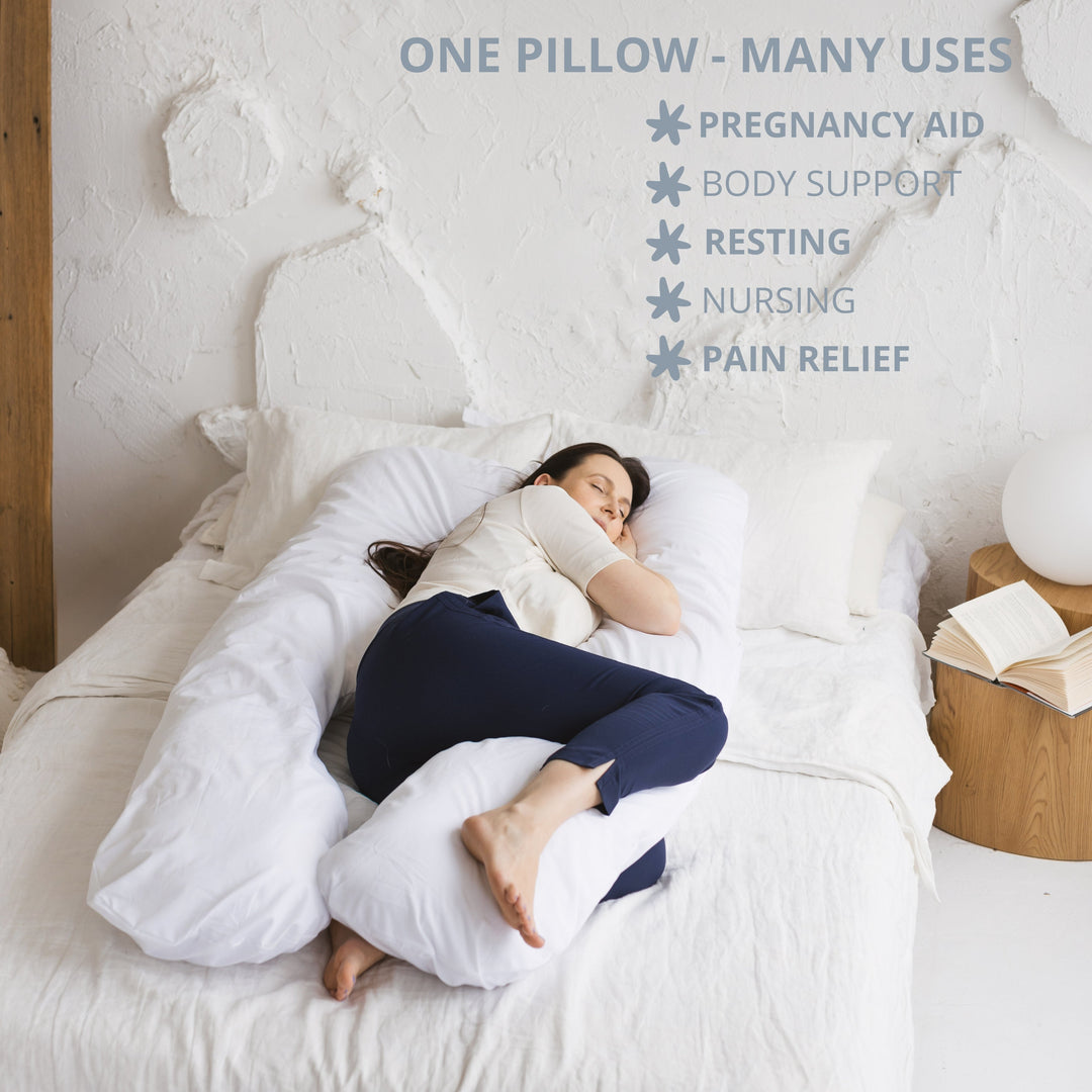 Woman lying on a large white pillow with text listing uses of the pillow including pregnancy aid, body support, resting, nursing and pain relief