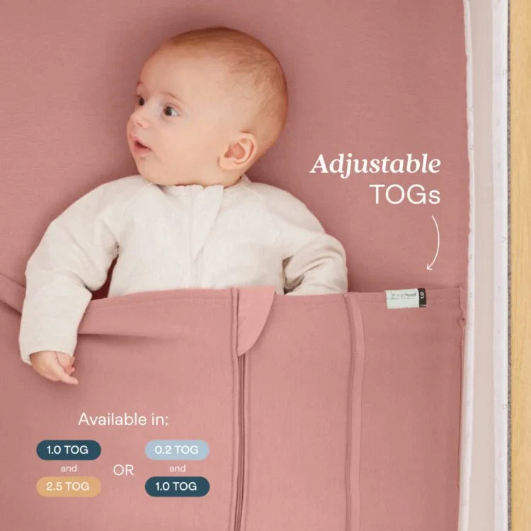 Baby lying in a pink sleeping bag with adjustable TOG options displayed.