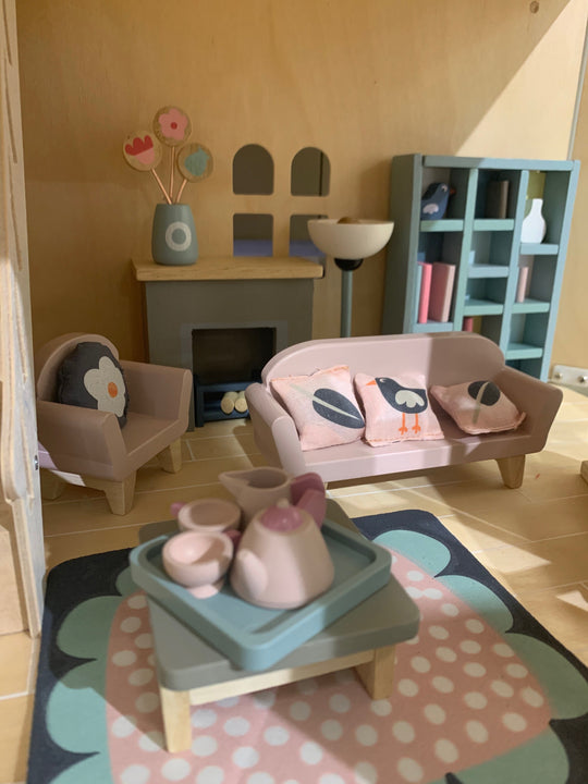 Children's playroom with wooden furniture, toys, and decor.