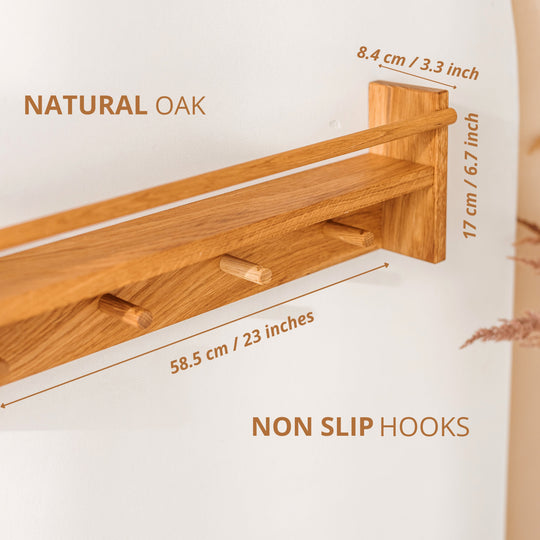 Close up of wooden shelf with measurements listed: width 58.5cm/23 inches, height 17cm/67 inches and depth 8.4cm/3.3 inches. It also states its features such as natural oak and non slip hooks