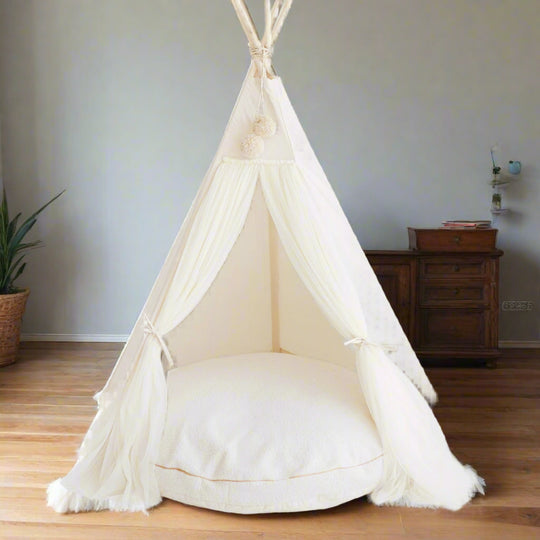 White children's teepee with a floor cushion inside