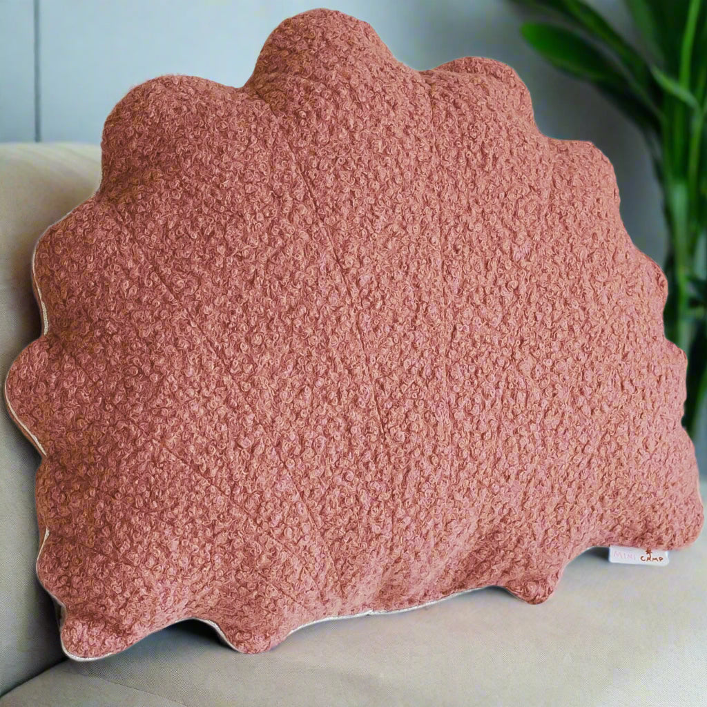 Pink textured cushion with scalloped edge