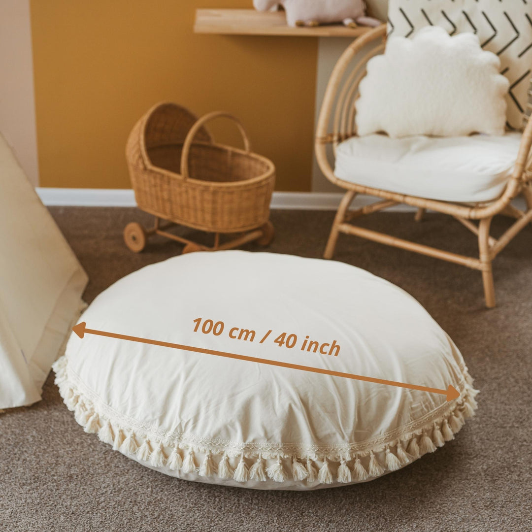 Round beige cushion with measurement text showing the diameter of the cushion is 100cm/40 inches
