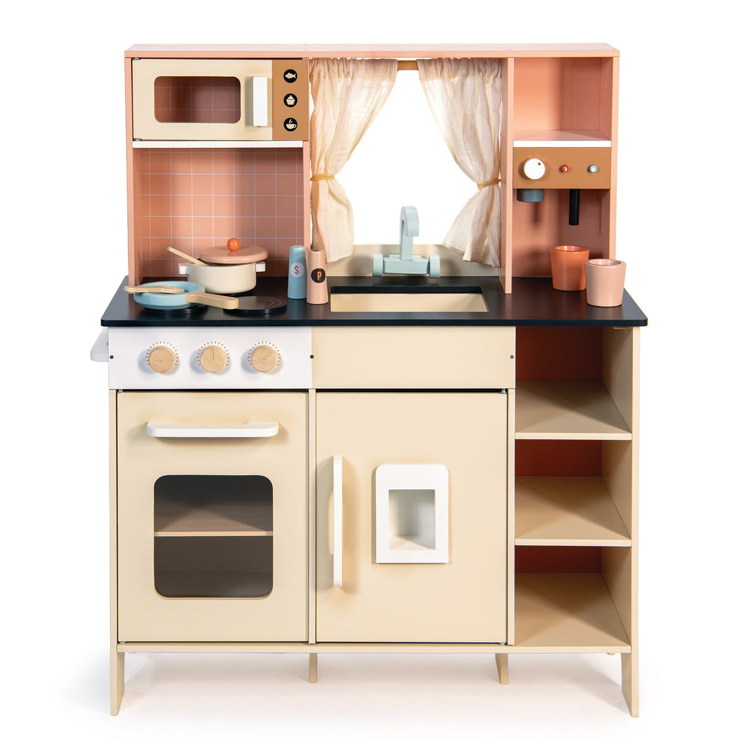 Wooden play kitchen set with various accessories on a white background