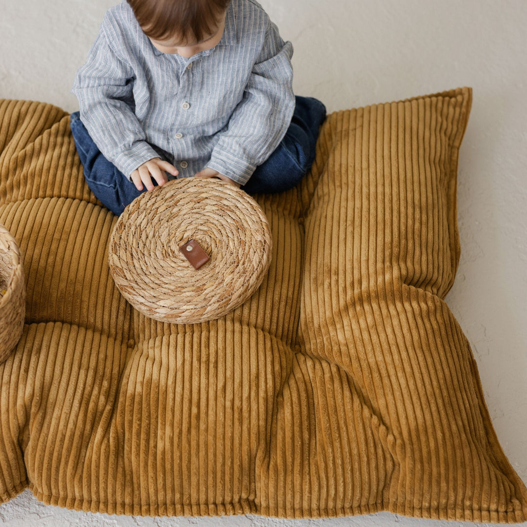 Closer view of the cushion showing its chunky corduroy stripes