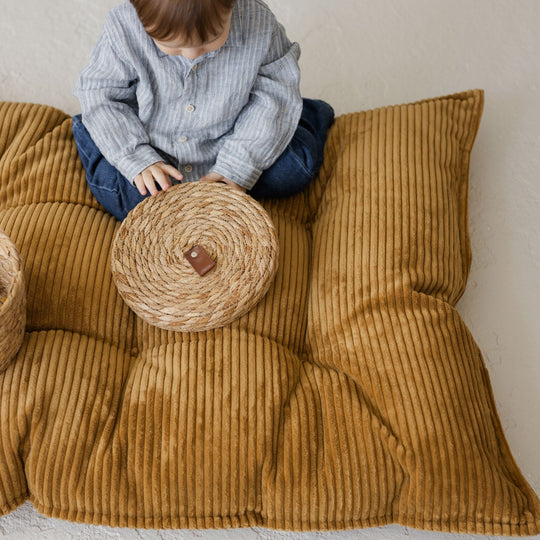 Closer view of the cushion showing its chunky corduroy stripes