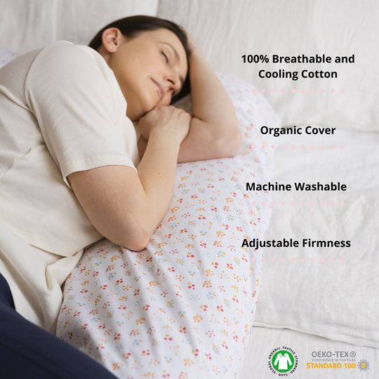 Person sleeping with U shaped support pillow with certain features listed such as 100% breathable and cooling cotton, organic cover, machine washable and adjustable firmness