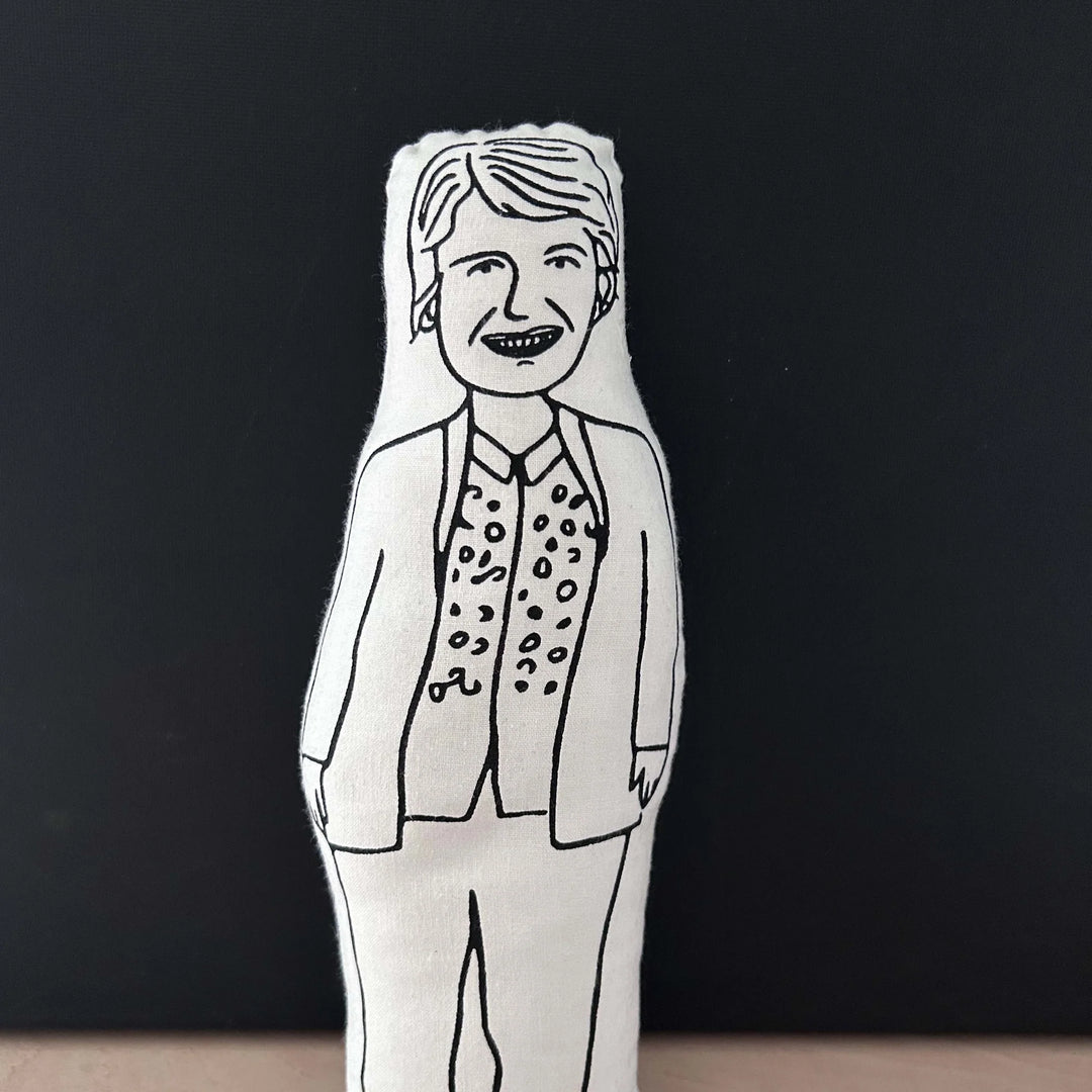 Screen printed black and white doll cushion depicting Sandi Toksvig against a dark background