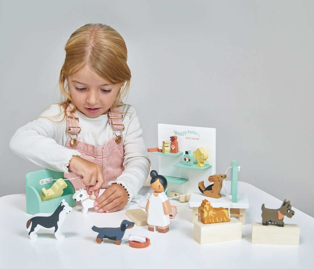 Child playing with wooden toys on a white surface