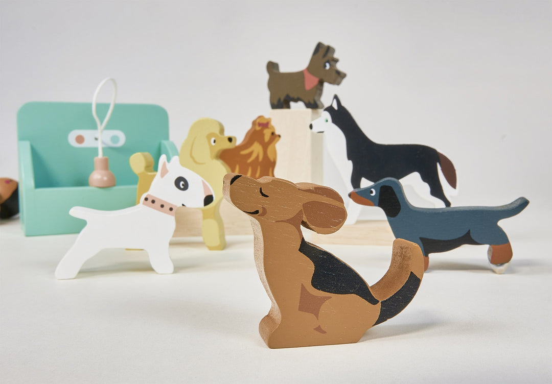 Set of colorful dog-shaped wooden toys on a white background