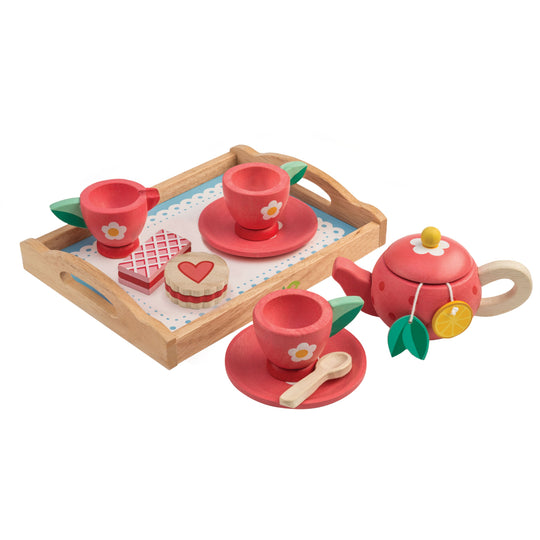 Wooden tea set with red teacups, saucers, a teapot, and tray on a white background