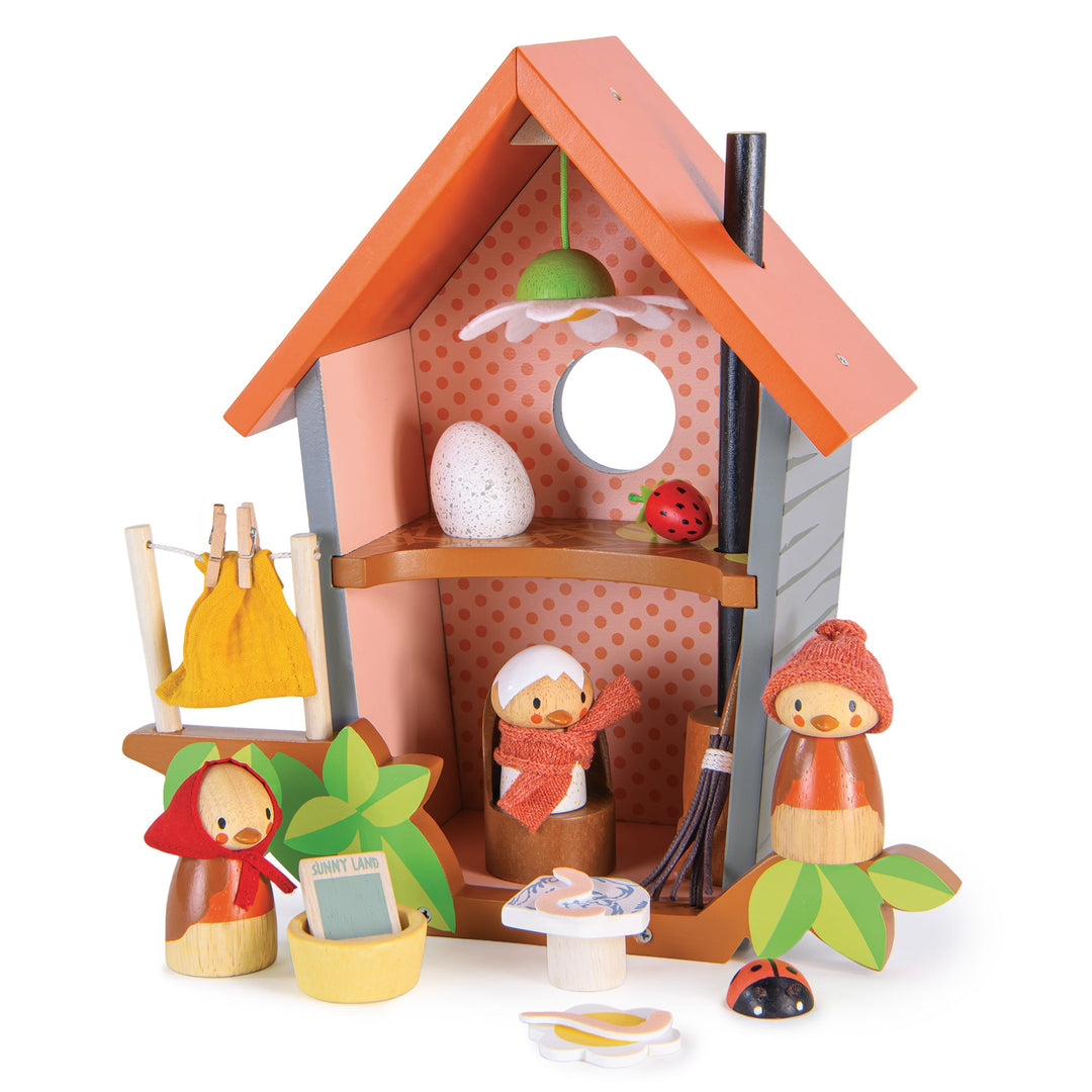 Wooden toy bird house with bird characters and accessories on a white background