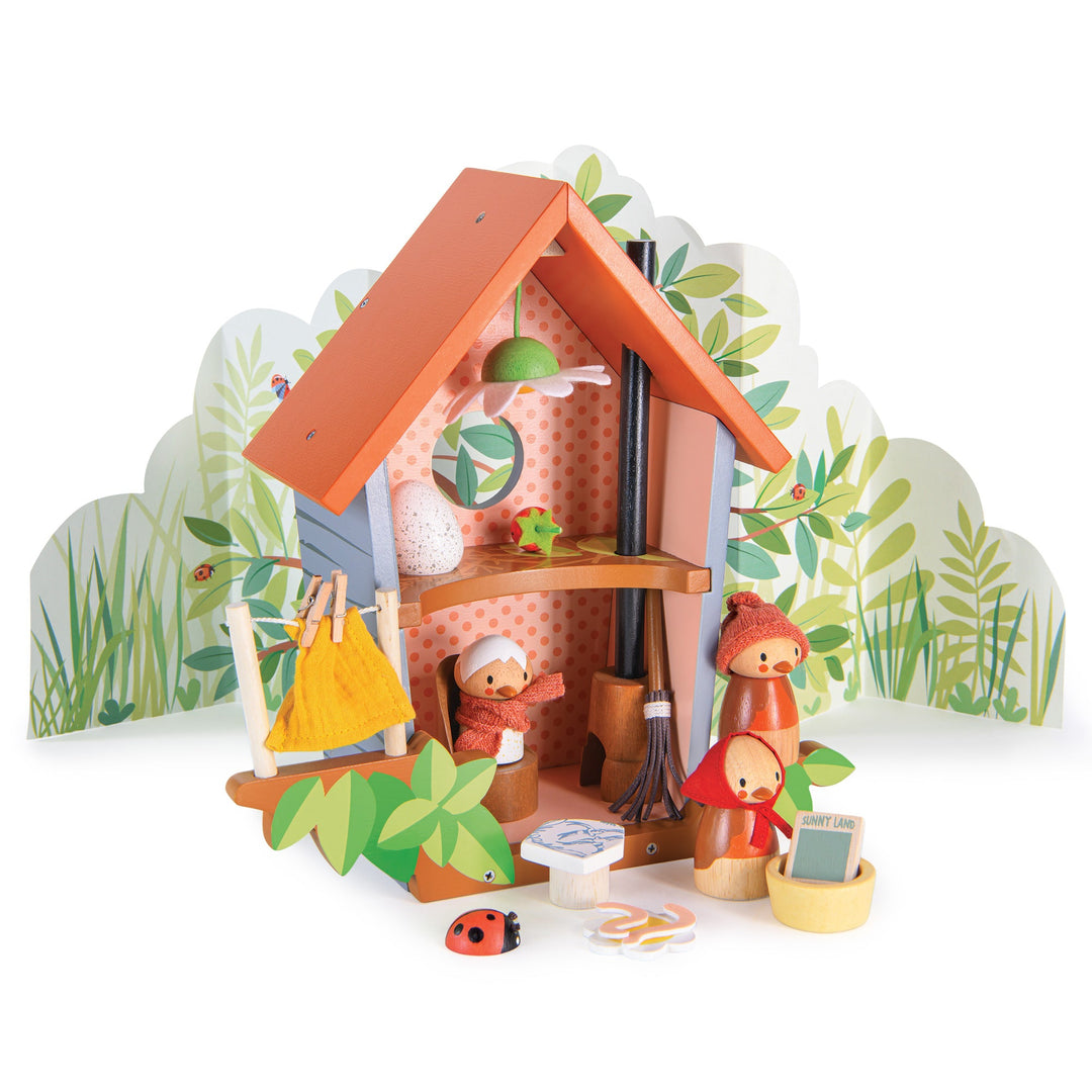 Toy playset with a small bird house, bird characters and accessories on a white background