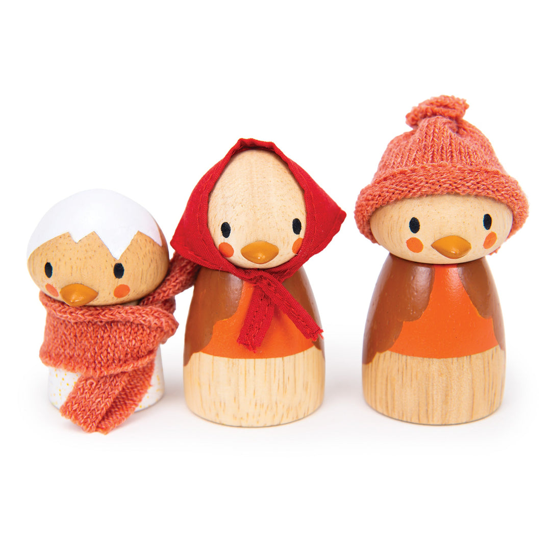 Three wooden robin bird toys with autumn-themed accessories such as a wooly hat, scarf and red head scarf on a white background